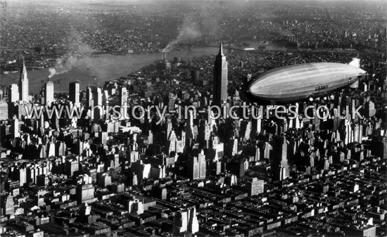 Airship flying over Midtown Manhattan, New York. c.1920's.